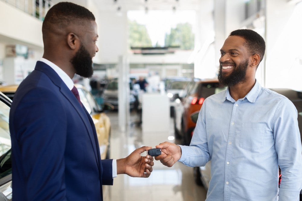 Salesman handing over keys